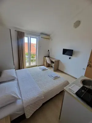a hotel room with a bed and a sink at Guest House Damjana in Budva