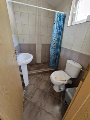 a bathroom with a toilet and a sink at Guest House Damjana in Budva