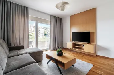 a living room with a couch and a flat screen tv at Status-M Apartments 103 in Becici