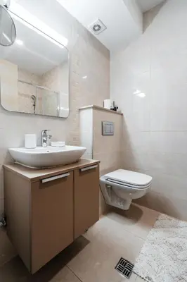 a bathroom with a sink and a toilet and a mirror at Status-M Apartments 103 in Becici