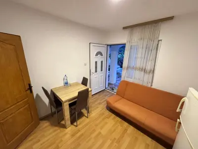 a living room with a couch and a table at Mon in Bar