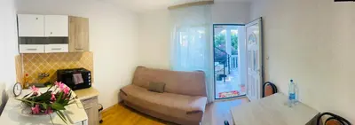 a living room with a couch and a table at Mon in Bar