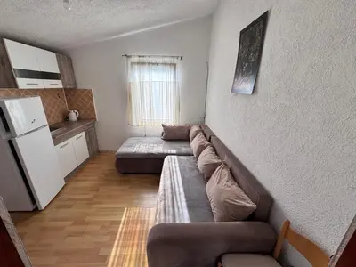 a living room with a couch and a refrigerator at Mon in Bar