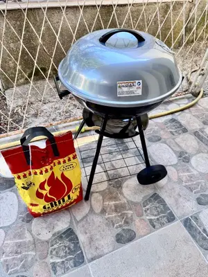 a grill with a bag next to a fence at Mon in Bar