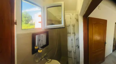 a bathroom with a toilet and a window at Mon in Bar