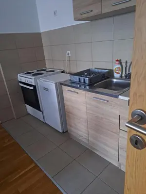a kitchen with a stove and a sink at Naki home in Pobrežje
