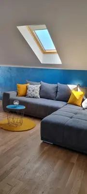 a living room with a couch and a skylight at Naki home in Pobrežje