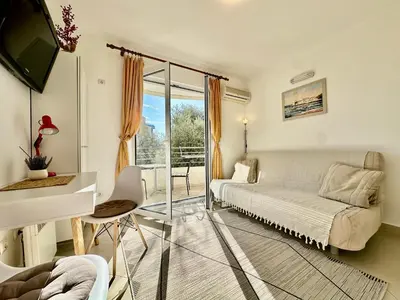 a bedroom with a bed and a desk and a window at Budva - Becici in Becici