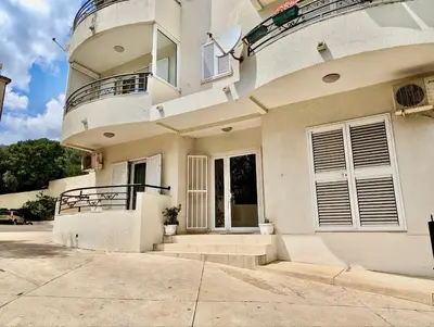 a large white house with a balcony on it at Budva - Becici in Becici