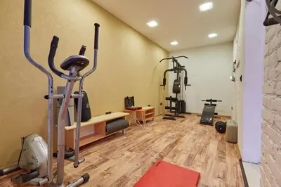 a gym with treadmills and exercise equipment in a room at Beachfront Villa Adria - Happy Rentals in Kotor
