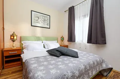 a bedroom with a bed with two pillows on it at Beachfront Villa Adria - Happy Rentals in Kotor