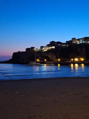 a view of the beach at night at Apartments Marovic in Ulcinj