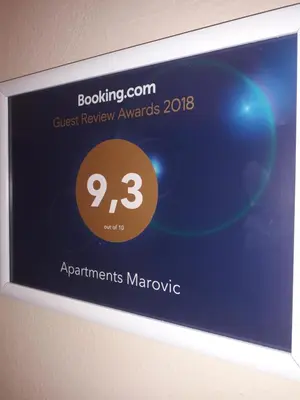 a sign on a wall that saysazon rewardsagents marmite at Apartments Marovic in Ulcinj