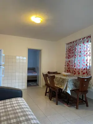 a dining room with a table and chairs in a room at Apartments Marovic in Ulcinj