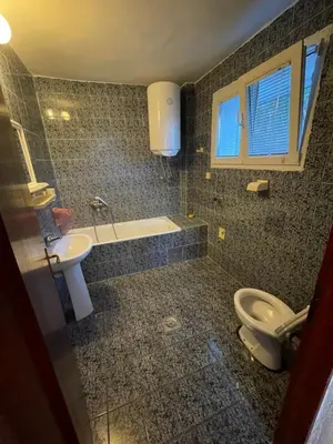 a bathroom with a toilet and a sink at Apartments Marovic in Ulcinj
