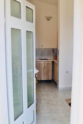 a kitchen with a door open to a room at Apartments Marovic in Ulcinj