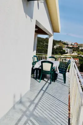 a patio with a table and chairs on a balcony at Apartments Marovic in Ulcinj