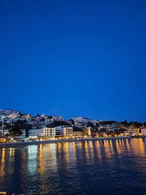 a view of a city from the water at night at Apartments Marovic in Ulcinj