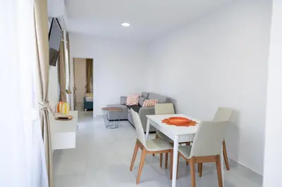a living room with a white table and chairs at Apartments Chiara Garden in Ulcinj