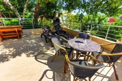 a group of tables and chairs on a patio at Buskovic Bella Vista in Dobra Voda