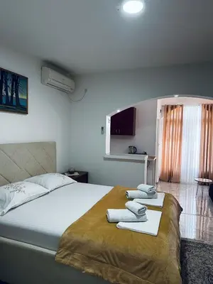 a bedroom with a bed with two towels on it at Apartments Duraku in Ulcinj