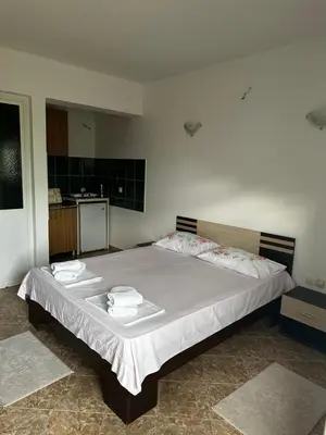 a bedroom with a large bed with towels on it at Apartments Duraku in Ulcinj