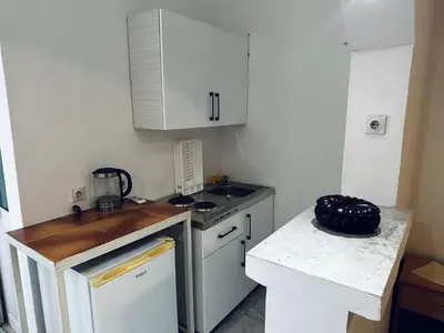 a small kitchen with a stove and a counter top at Apartments Duraku in Ulcinj