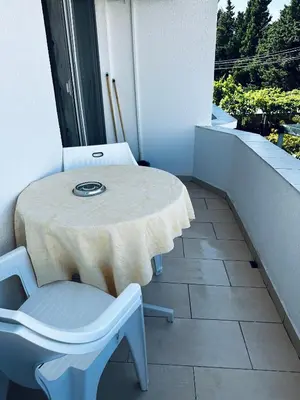 a table and a chair on a balcony with a table at Apartments Duraku in Ulcinj