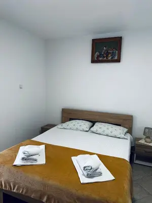 a bedroom with a bed with towels on it at Apartments Duraku in Ulcinj