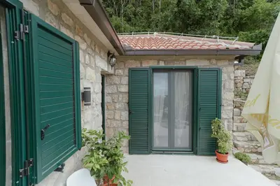 a green door on a stone house with at Casa di Pietra in Kotor