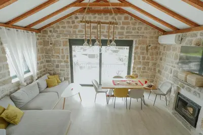 a living room with a couch and a table at Casa di Pietra in Kotor