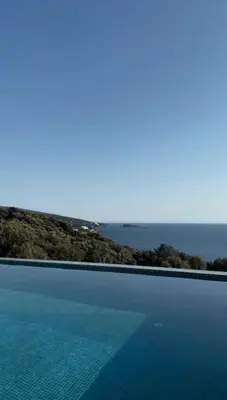 a swimming pool with the ocean in the background at Luxury Villa Lorcrimar in Masline