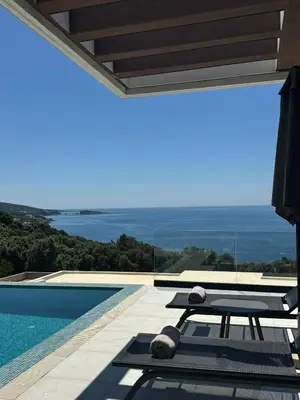 a pool with a table and a view of the ocean at Luxury Villa Lorcrimar in Masline