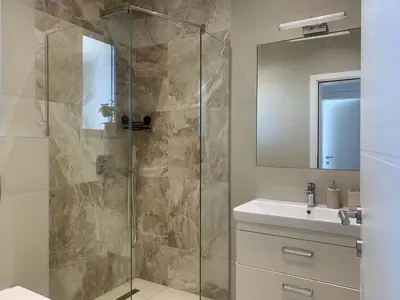a bathroom with a shower and a sink at Luxury Villa Lorcrimar in Masline