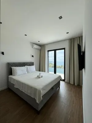 a bedroom with a large bed and a large window at Luxury Villa Lorcrimar in Masline