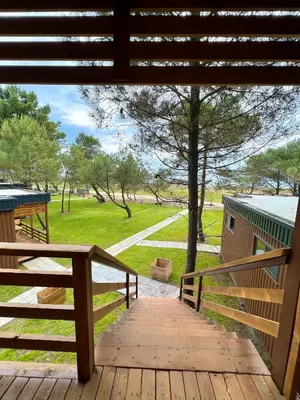 a wooden porch with a view of a park at Imperial Family Bungalows in Ulcinj