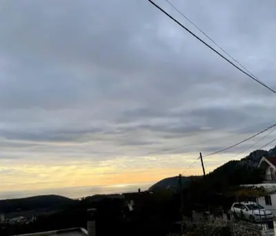 a view of a city with the sunset in the background at Sutomore Panorama Apartment in Sutomore