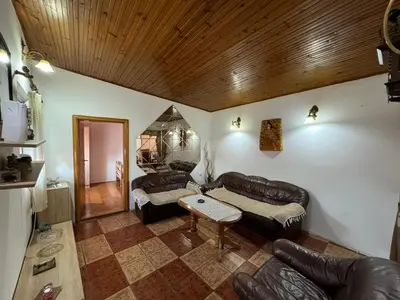 a living room with leather furniture and a wooden ceiling at Vlado apartments in Podgorica