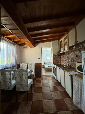 a kitchen with a table and chairs in a room at Vlado apartments in Podgorica