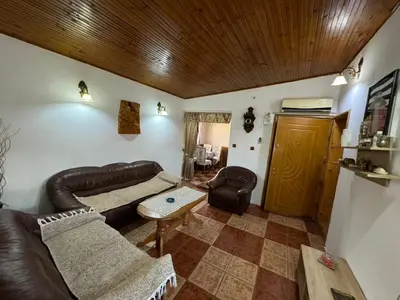 a living room with a leather couch and a table at Vlado apartments in Podgorica