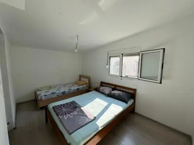 a bedroom with two beds and a window at Vlado apartments in Podgorica
