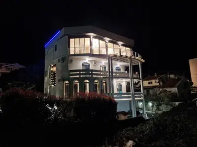 a building with a blue light on it at night at Villa Glamour in Utjeha