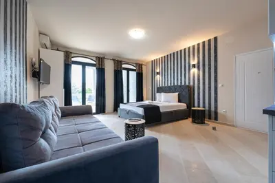 a living room with a bed and a couch at Villa Glamour in Utjeha