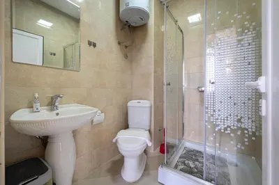 a bathroom with a toilet and a sink and a shower at Villa Glamour in Utjeha