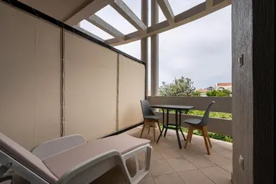 a small balcony with a table and chairs at Villa Glamour in Utjeha