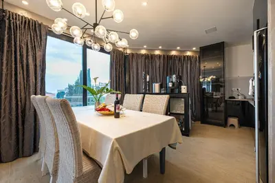a dining room with a white table and a large window at Villa Glamour in Utjeha
