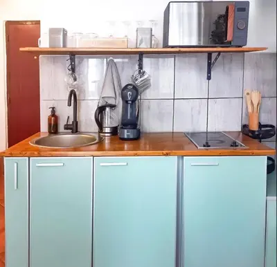 a kitchen counter with a sink and a microwave at B&L Chic apartment in Škaljari