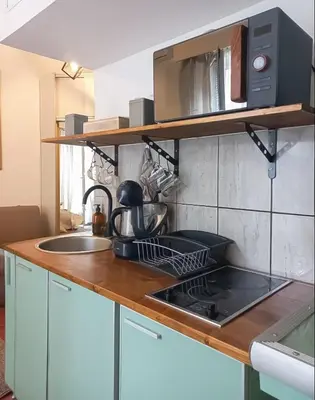 a kitchen with a sink and a microwave at B&L Chic apartment in Škaljari