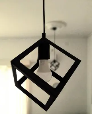 a black and whiteendant light hanging from a ceiling at B&L Chic apartment in Škaljari