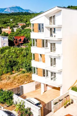 an aerial view of a white apartment building at Apartments Magic box II in Utjeha